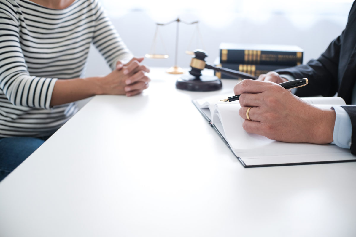 woman sitting across from man with gavel