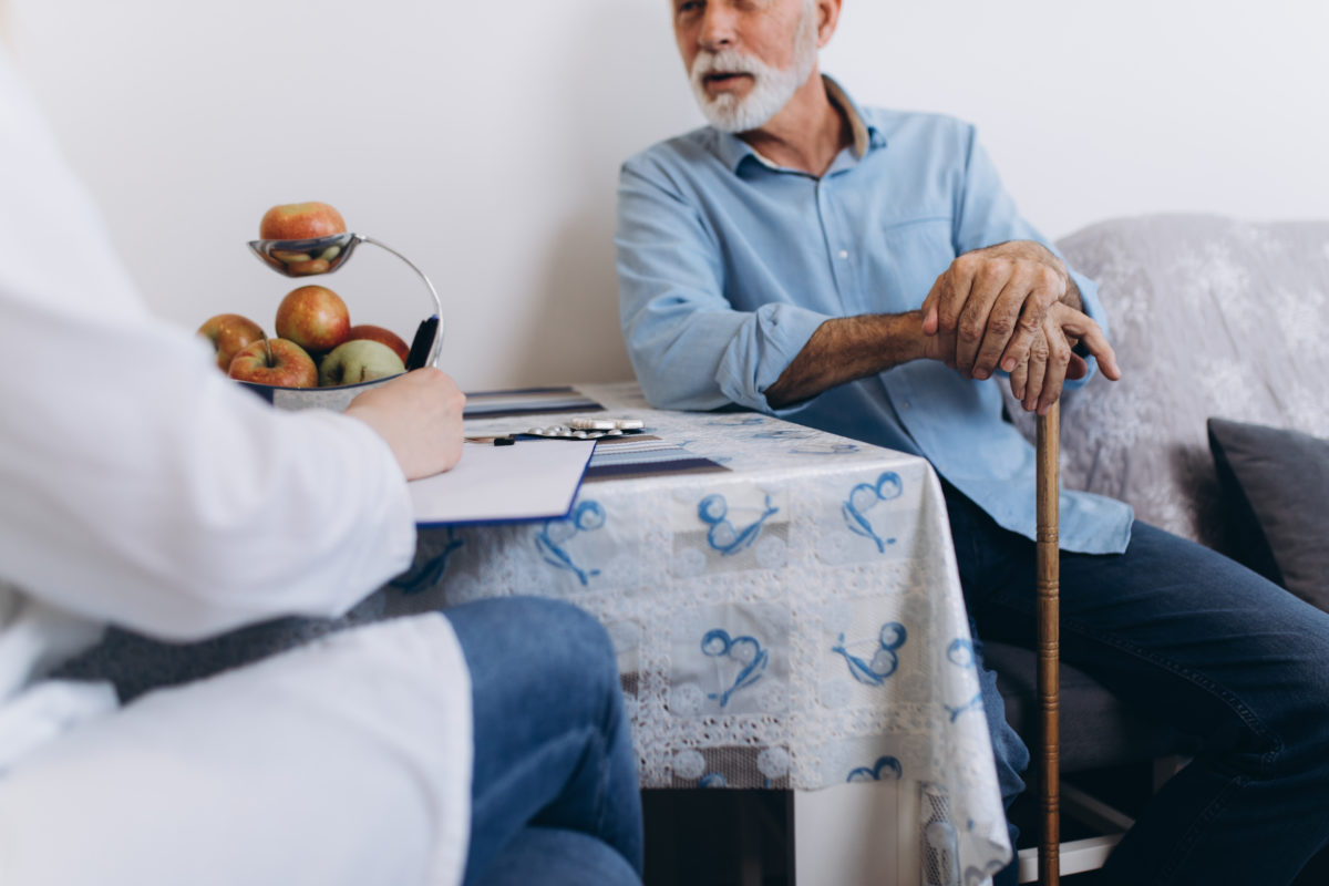 older man talking to another person