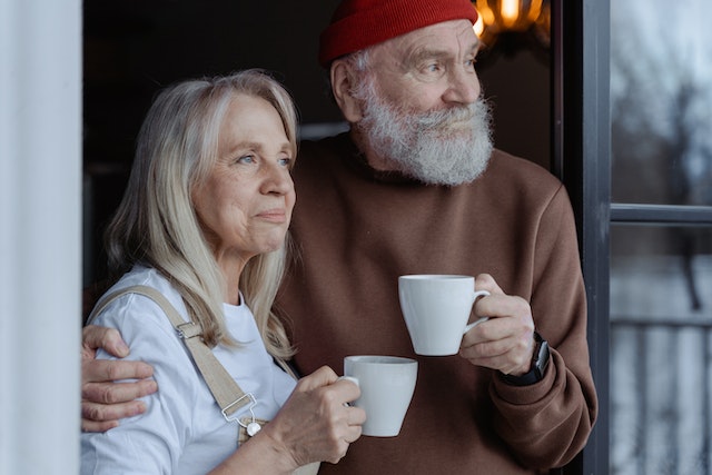 couple smiling holding coffee