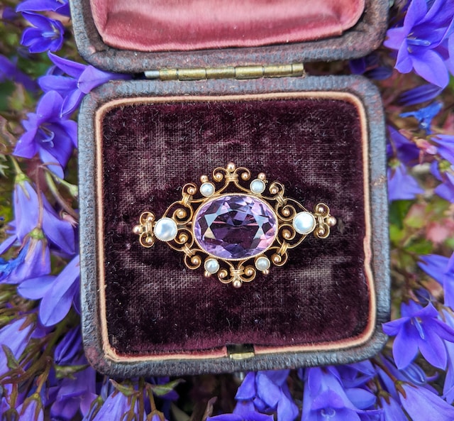 antique ring with ornate setting in box on floral background