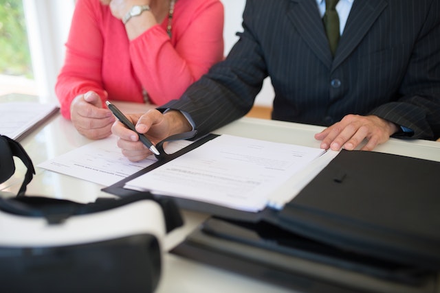 man and woman sitting in front of paperwork