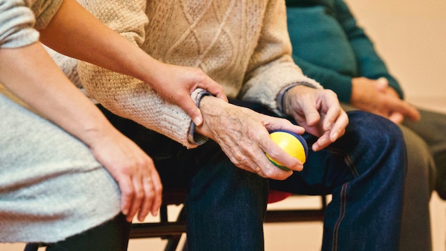 elderly man holding ball