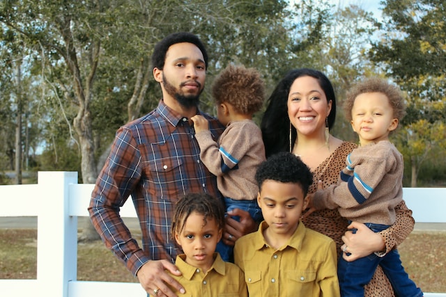 woman and man holding children