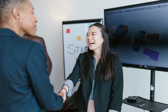 smiling woman shaking hands