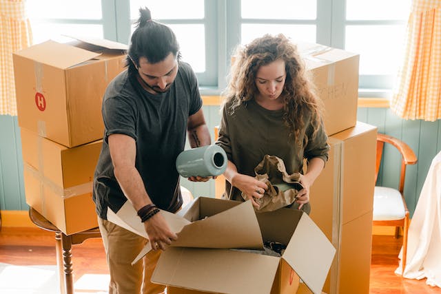 couple packing up boxes to move