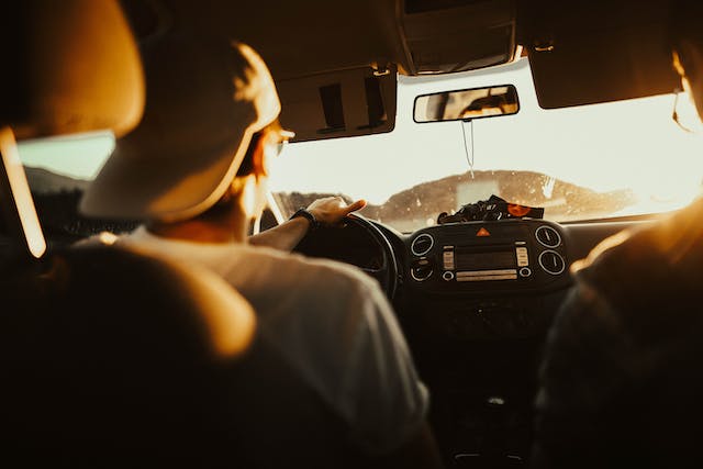 man with backwards hat driving