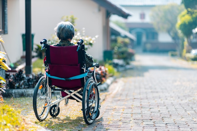 person sitting in a wheel chair outside