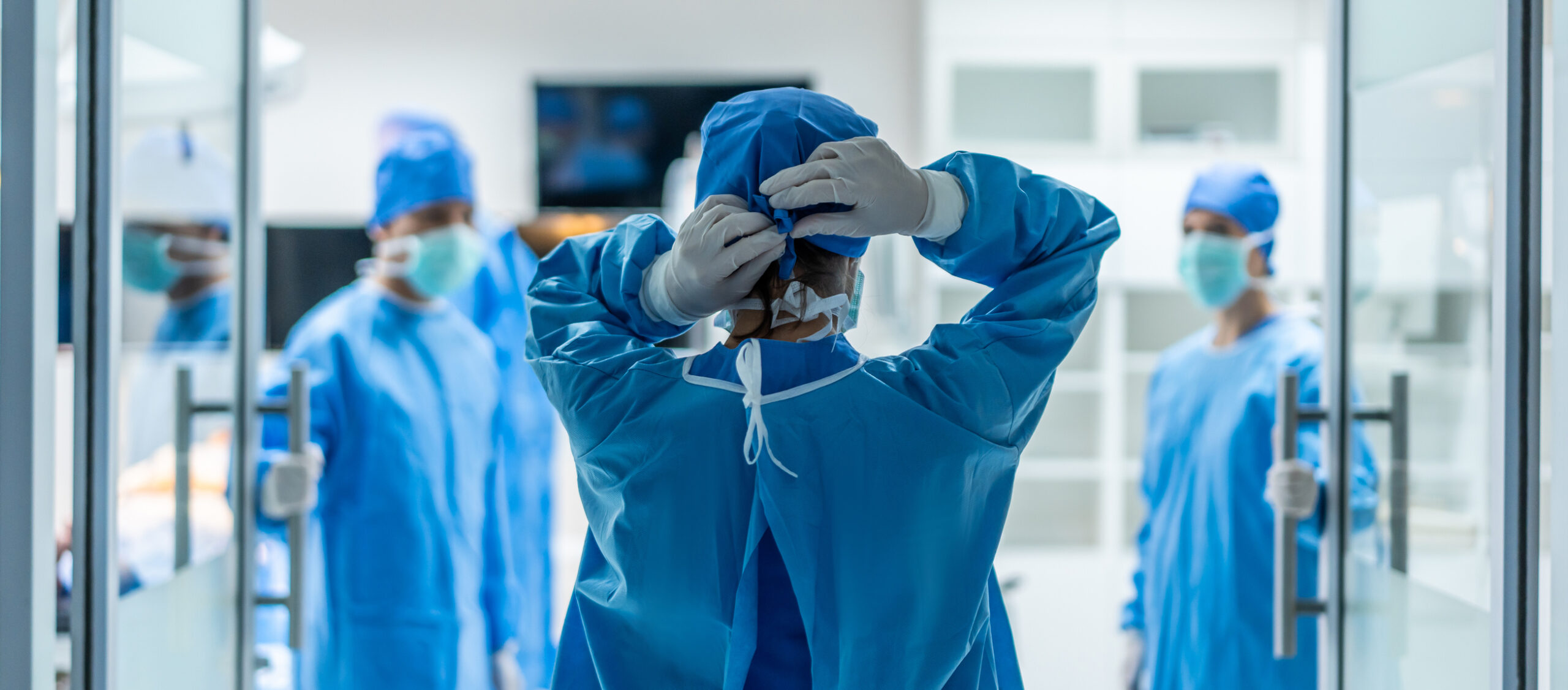 Professional doctors performing surgical operation in operating room. Attractive specialist medic surgeon medical team working and operation sick patient on intensive care patient in hospital ward.